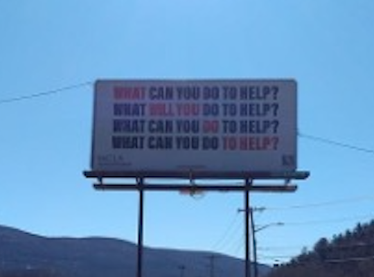 Photo of billboard reading What Will You Do To Help?