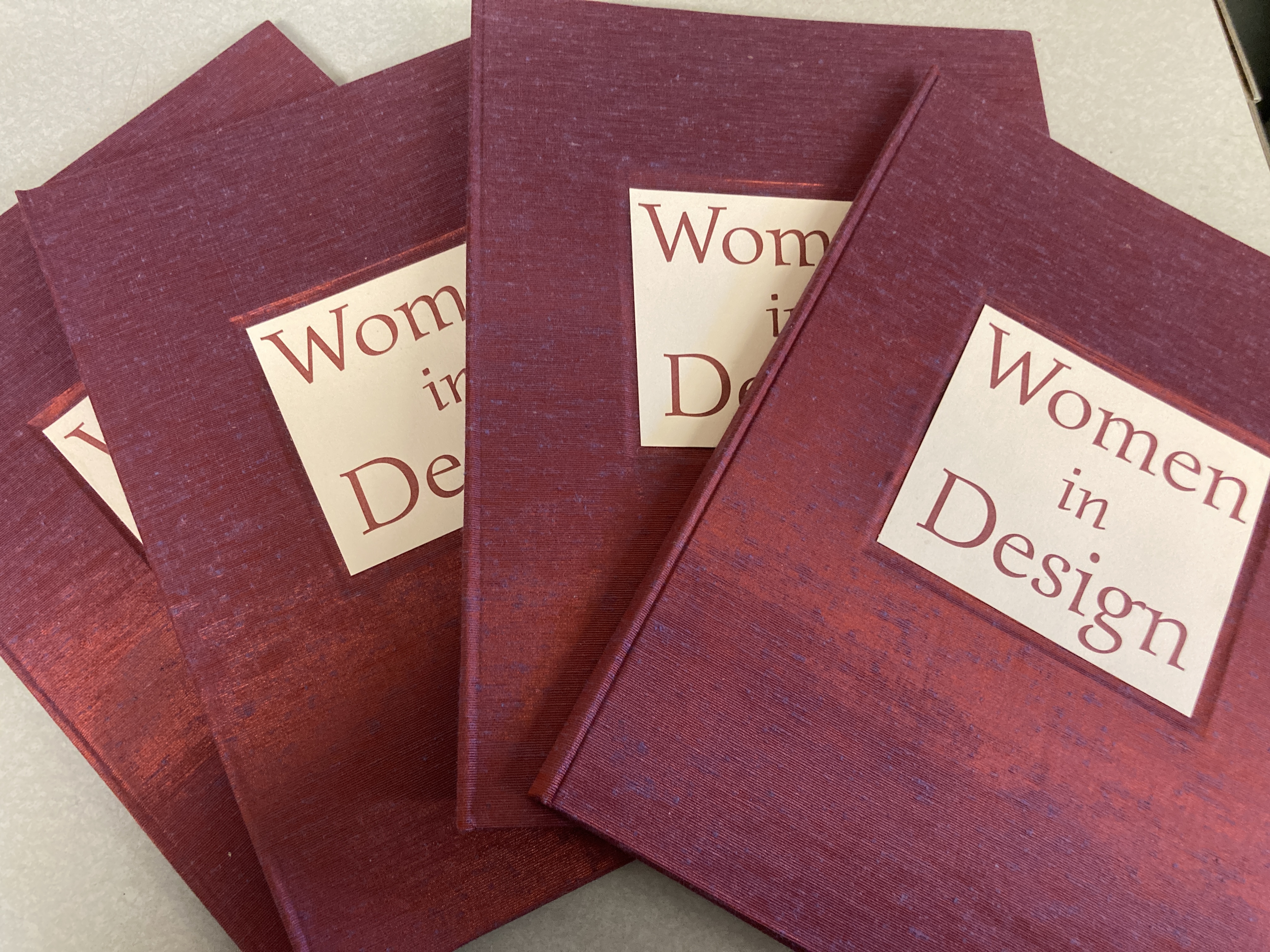Four hardcover books titled Women in Design