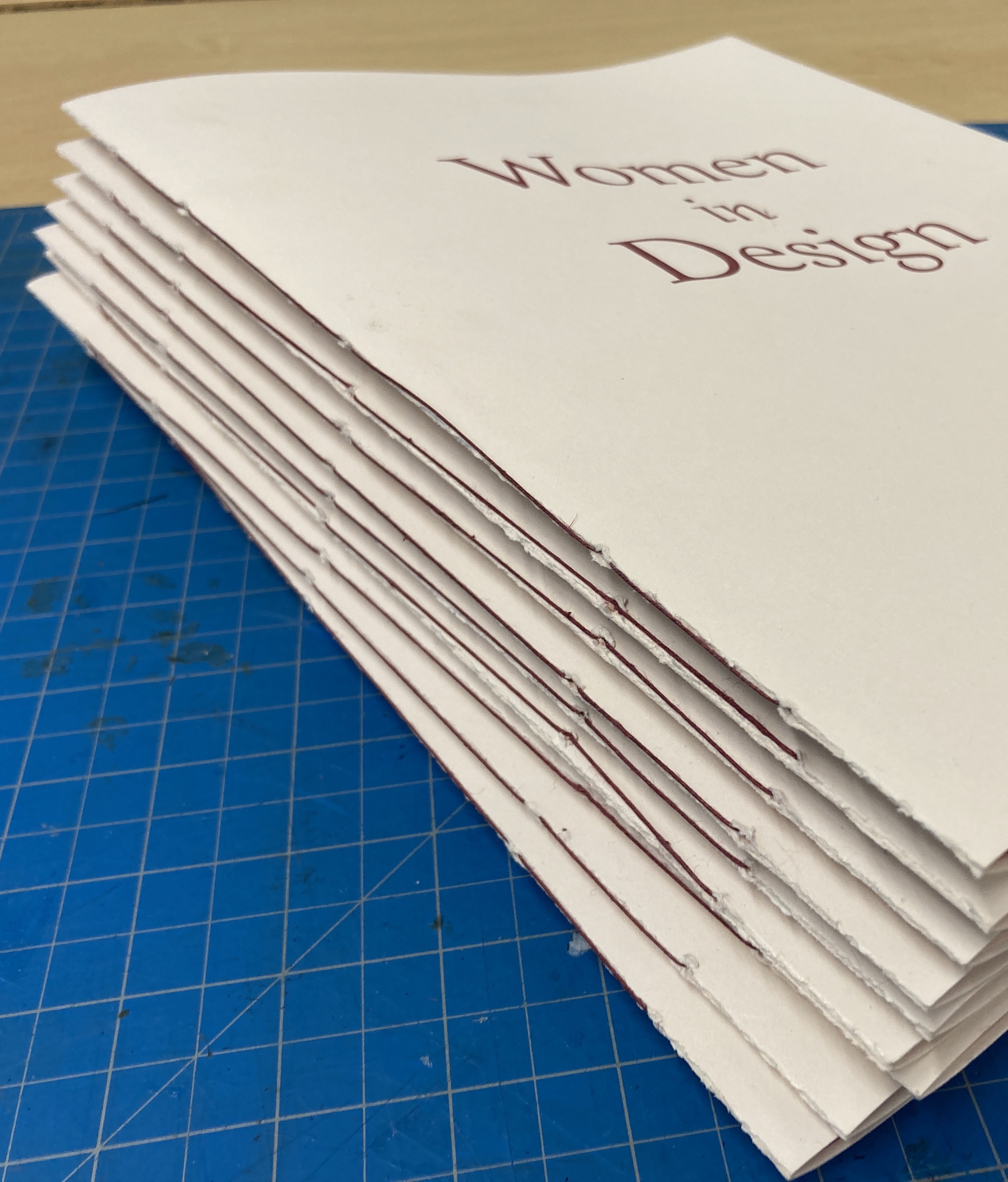 Stack of softcover editions of Women in Design